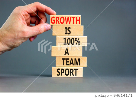 Growth symbol. Concept words Growth is 100 percent a team sport on wooden blocks on a beautiful grey table grey background. Businessman hand. Business motivational and growth is a team sport concept. Growth symbol. Concept words Growth is 100 percent a team sport on wooden blocks on a beautiful grey table grey background. Businessman hand. Business motivational and growth is a team sport concept. 94614171