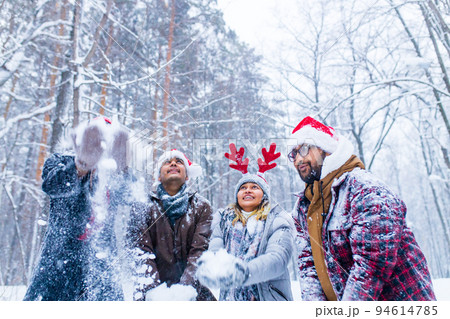 Happy friends is having fun and enjoying first snow wear fun hat and deer horn Happy friends is having fun and enjoying first snow wear fun hat and deer horn 94614785