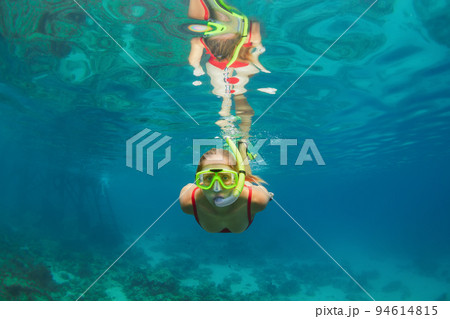 Child in snorkelling mask dive underwater with tropical fishes Child in snorkelling mask dive underwater with tropical fishes 94614815