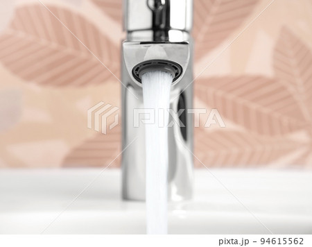 Water running from Faucet tap in white sink 94615562