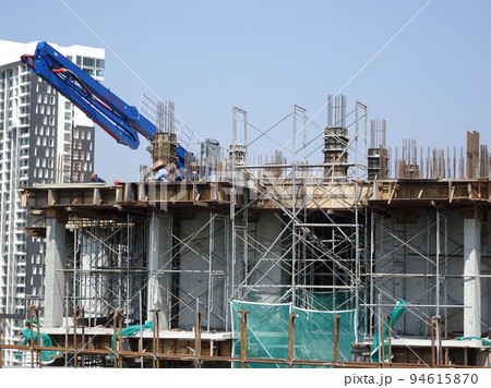MELAKA, MALAYSIA -MAY 8, 2022: Temporary staircase made of steel and scaffolding that connects floor by floor. Used by construction workers. This ladder is wrapped with safety netting. MELAKA, MALAYSIA -MAY 8, 2022: Temporary staircase made of steel and scaffolding that connects floor by floor. Used by construction workers. This ladder is wrapped with safety netting. 94615870