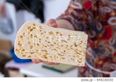 Homemade Caucasian cheese or Bryndza cut in slices at local market Homemade Caucasian cheese or Bryndza cut in slices at local market 94616030