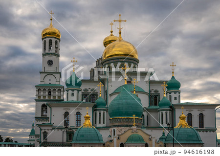 Orthodox church with gilded domes against a dramatic sky 94616198