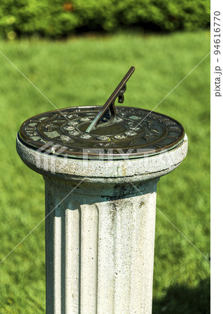 antique sundial on a pedestal in sunny day in garden, New Jersey Botanical Garden antique sundial on a pedestal in sunny day in garden, New Jersey Botanical Garden 94616770