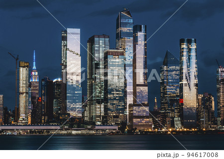 Manhattan midtown skyline, seen from across the Hudson River at night. Beautiful reflections and light. Manhattan midtown skyline, seen from across the Hudson River at night. Beautiful reflections and light. 94617008