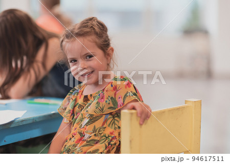 Creative kids sitting in a preschool institution, draw and have fun while they get an education 94617511