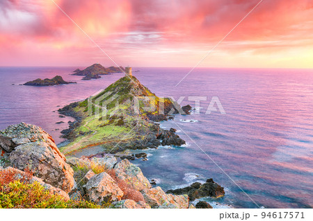 Sunset over popular tourist destination Torra di a Parata with Genoese Tower Sunset over popular tourist destination Torra di a Parata with Genoese Tower 94617571