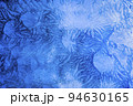 Abstract frosty pattern on glass, background texture on the window 94630165