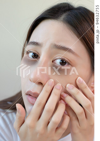 Asian young female stress looking mirror have dark eye circles from staying up sleepy late. 94632755