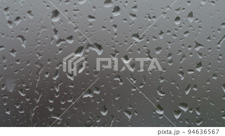 Real background of rain hitting glass window 94636567