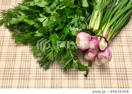 a bunch of green dill and parsley, spring onions on a rustic checkered table cloth, concept of fresh vegetables and healthy food a bunch of green dill and parsley, spring onions on a rustic checkered table cloth, concept of fresh vegetables and healthy food 94639368