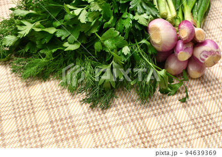 a bunch of green dill and parsley, spring onions on a rustic checkered table cloth, concept of fresh vegetables and healthy food a bunch of green dill and parsley, spring onions on a rustic checkered table cloth, concept of fresh vegetables and healthy food 94639369