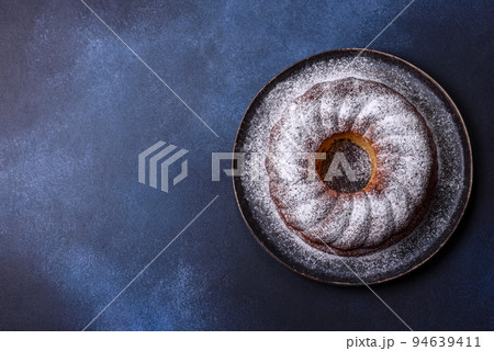 Homemade delicious round Christmas pie with red berries on a ceramic plate 94639411