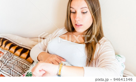 Pregnant time go hospital. Pregnant holding baby belly, woman watching clock. Childbirth time, contractions pain. Concept maternity, pregnant, childbirth. 94641346