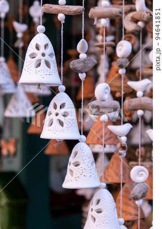 Ceramic handycrafts sold in the shops sold in Sopot Poland. Candid souvenir travel gifts. Clay bells hang on a rope. Shallow depth of field 94641851