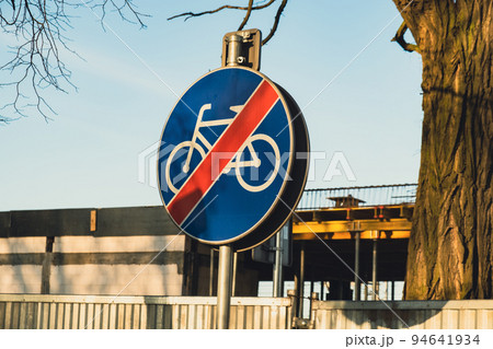 End of road for bicycles. prohibition sign no bicycle, road sign. No bikes, bikers cyclists allowed blue street sign closeup. Bike laws, regulations, no bike no cycle zone, cycling not allowed simple 94641934