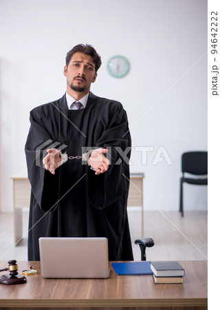 Young male judge in corruption concept 94642222