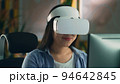 Woman in VR headset working on pc 94642845