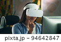 Woman in VR headset working on pc 94642847