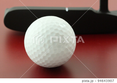 golf ball on red surface and club golf ball on red surface and club 94643907