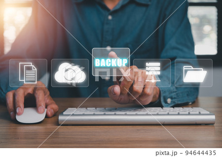Backup storage data internet technology business concep, Businessman using a computer with VR screen backup icon on desk. 94644435
