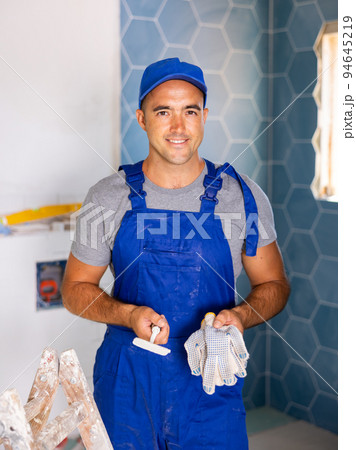 Portrait of positive man worker in bathroom 94645219