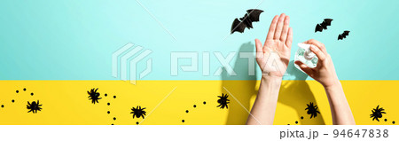 Applying sanitizer gel with Halloween theme 94647838