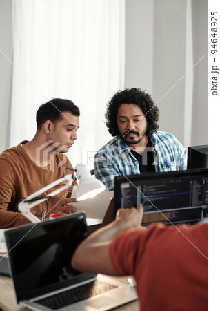 Programmers discussing new releasing new feature on website 94648925