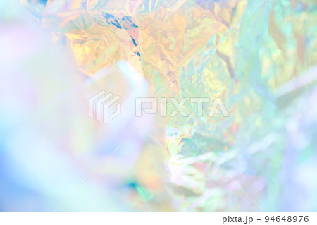 Iridescent texture. Holographic background. A hologram of gradient neon color. Foil effect. Rainbow graphics. Chrome-plated space design for prints. High quality photo 94648976