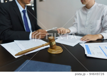 Lawyer and legal concept, Businessman receives a pen from senior lawyer to signing contract Lawyer and legal concept, Businessman receives a pen from senior lawyer to signing contract 94649726