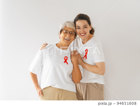 Smiling women with red satin ribbon 94651608