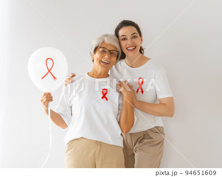 Smiling women with red satin ribbon 94651609