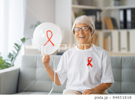 Smiling woman with red satin ribbon Smiling woman with red satin ribbon 94651616