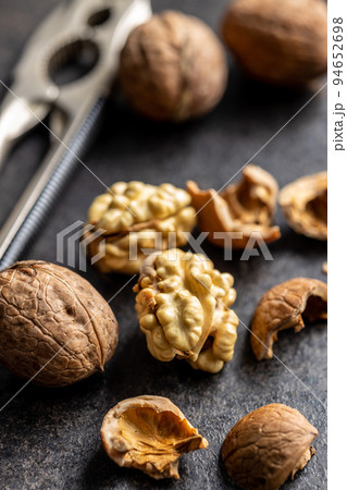 Peeled walnut on dark table. Peeled walnut on dark table. 94652698