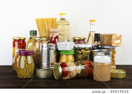 Emergency survival food set on dark wooden kitchen table 94654916