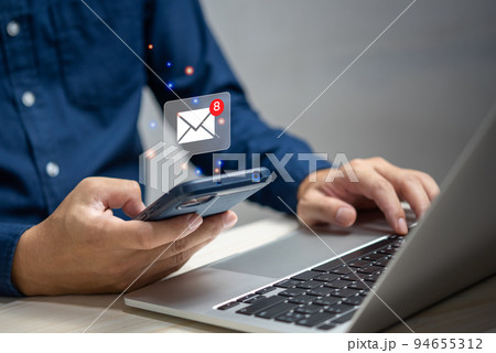 businessman holding hand touchscreen smartphone and checking email icon online or sending mail to partner and customer on web with virtual interface technology concept. 94655312