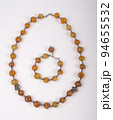 Set of necklace and bracelet made of brown colored stone decorated by silver 94655532