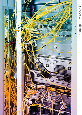 close-up of yellow fiber optic cables connected to server inside server rack 94655731