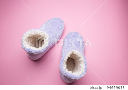 Soft blue homemade ugg boots on a pink background. 94659033