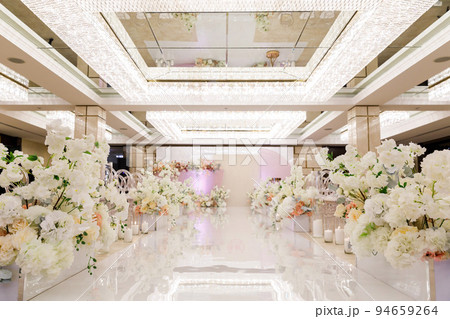 Wedding ceremony with rows of flowers in the hall Wedding ceremony with rows of flowers in the hall 94659264