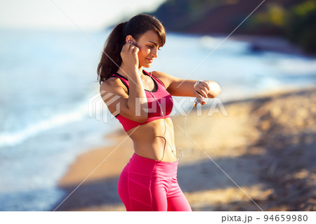 Fitness runner woman running on beach. Sporty athlete training cardio barefoot with determination. Fitness runner woman running on beach. Sporty athlete training cardio barefoot with determination. 94659980