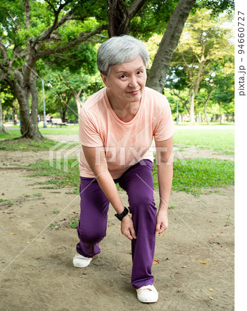 Portrait of 60s senior adult elderly asia woman smiling standing with towel after sport and enjoy with nature fresh air in the park. Portrait of 60s senior adult elderly asia woman smiling standing with towel after sport and enjoy with nature fresh air in the park. 94660727