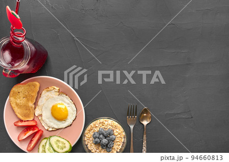 Top view of healthy and delicious breakfast on a black background with copyspace. Top view of healthy and delicious breakfast on a black background with copyspace. 94660813