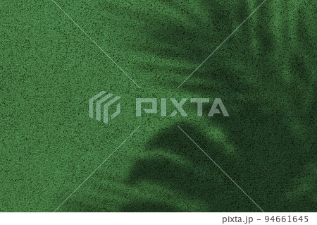 Shadow of leaves on bright green concrete wall texture background Shadow of leaves on bright green concrete wall texture background 94661645