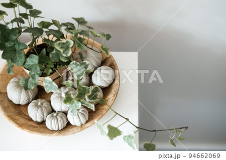 Sustainable Eco-Friendly Zero Waste Thanksgiving banner. Minimal Thanksgiving Halloween decorative composition of clay pumpkins and green house plant in wooden plate 94662069