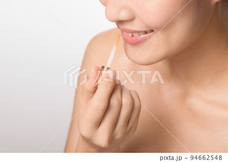 Portrait young asian woman looking mirror applying makeup lipstick at room 94662548