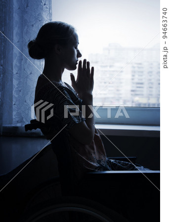 Young person in stroller by window Young person in stroller by window 94663740