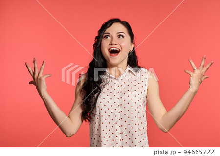 Studio shot of a beautiful girl teenager posing over a pink background. 94665722