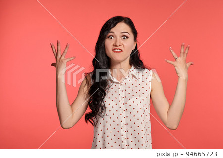 Studio shot of a beautiful girl teenager posing over a pink background. 94665723