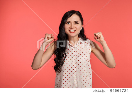 Studio shot of a beautiful girl teenager posing over a pink background. 94665724